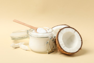 Coconut and cosmetic on beige background. Tropical fruit