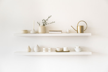 Minimalistic. Cozy light home style. Scandinavian interior. Dishes on white shelves. White details in the interior. 