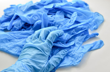 Disposable latex gloves in blue. Antiseptic in a transparent flocon