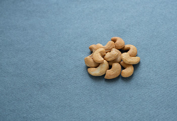 Fototapeta na wymiar Cashew nuts on a blue background