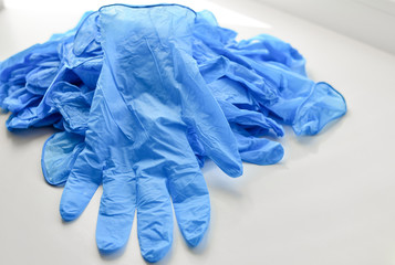 Disposable latex gloves in blue. Antiseptic in a transparent flocon