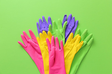 Set of rubber gloves on color background