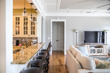Simple living room with furniture and a white fireplace in between two back glass doors