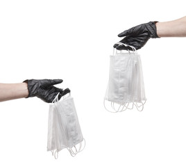 hands in rubber nitrile gloves pass medical masks, isolated on white, concept personal protective equipment against coronavirus