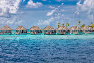 Perfect aerial landscape, luxury tropical resort or hotel with water villas and beautiful beach scenery. Amazing bird eyes view in Maldives, landscape seascape aerial view over a Maldives