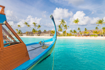 Exotic Maldives beach landscape. Maldives traditional boat Dhoni and perfect blue sea with lagoon. Luxury tropical paradise concept. Amazing landscape
