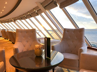 Luxurious observation or panorama lounge with floor to ceiling windows onboard Azamara Club Cruises...