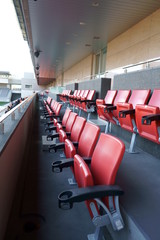 Orange spectator seats in a sports stadium