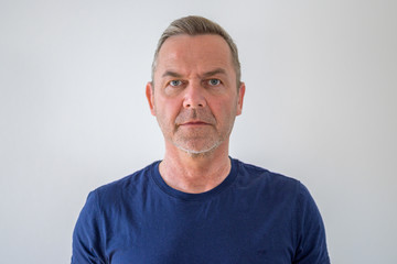 Bust portrait of middle-aged man in blue t-shirt