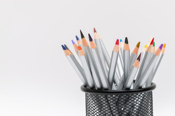 gray wooden pencils with colored rods on a white background