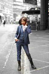a young woman dressed in a tweed suit smoking