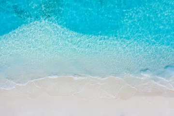 Keuken spatwand met foto Tranquil tropical beach sea shore. Coast of exotic aerial sea and sand, view from above. Soft waves splashing, calm beach © icemanphotos