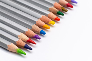 Naklejka premium gray wooden pencils with colored rods on a white background