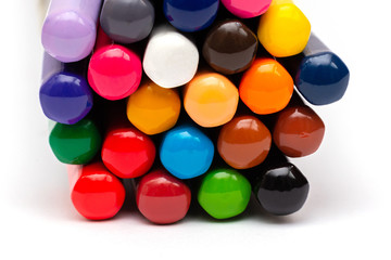 colored back of wooden gray pencils with colored rods on a white background