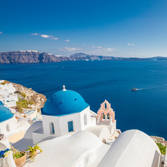 Fototapeta na wymiar Oia village, Santorini, Greece. Vacations and travel destination background. White architecture with blue dome. Peaceful and tranquil summer mood, travelling landscape