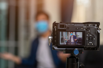 [Work from home] videoblog and people concept - camera recording video blog of asians male blogger at home. The concept of a campaign to wear a mask to protect the corona virus.