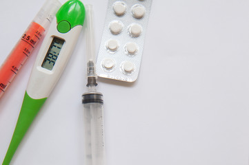 Medical concept. Drugs, thermometer and syringe. Copy space. Top view