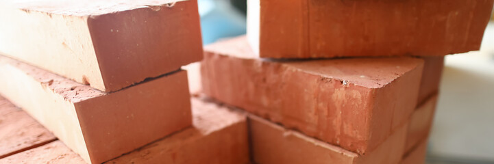 Building materials are on floor, stack red bricks
