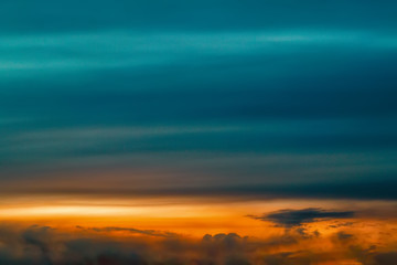 Fototapeta premium The sky at sunset. Cumulus clouds lit by the rays of the setting sun.