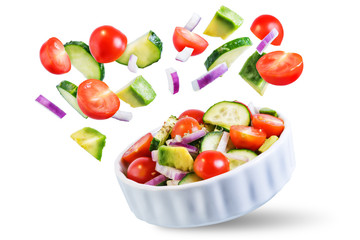 Cucumber tomato avocado red onion salad on a white isolated background