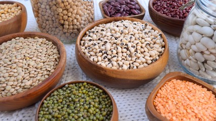 Eco Life And Healthy Food Concept. Organic Beans In Wooden Bowls And Glass Jars.