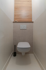 Empty toilet (wc) room with white walls and tiles