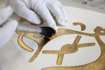 gold gilding leaf decoration with brush closeup