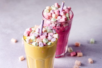 Two Glasses of Tasty Fruit Smoothies or Colored Milk Shake Decorated With Marshmallow Close Up Horizontal
