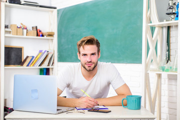 online college life. school teacher use laptop and smartphone. modern education concept. back to school. Working day morning. man make note and drink coffee. student man in classroom with tea cup