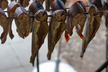 Nahaufnahme von geräuchertem Fisch an Spießen 