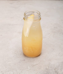 lemonade, lemonade with ice in a glass bottle on a white background