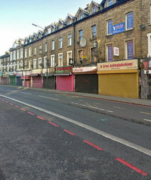 London, United Kingdom - March 31, 2020: Line Of Shops With Shutters Closed On Lee High Street During Coronavirus Outbreak. These Are Usually Open Even On Sundays But Were Forced To Close Due To Virus