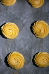 dough for eclairs on baking paper