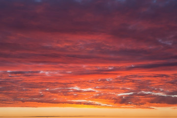 Epic Dramatic bright sunrise, sunset orange yellow pink sky with clouds background texture, heaven