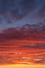 Fototapeta na wymiar Epic Dramatic bright sunrise, sunset orange yellow pink blue sky with clouds background texture, heaven