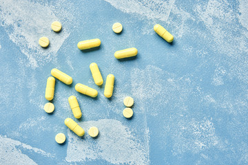 yellow pills on a blue background. view from above.