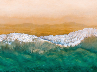 Fototapeta na wymiar Top view on sandy beach and emerald ocean water. Aerial photography