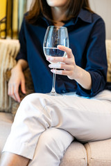 the woman relaxes and drinks a glass of wine