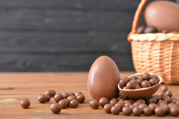 Chocolate eggs and candies on wooden table