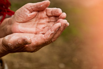 Fototapeta premium Old grandmother washes her hands with soap close-up. Soapy hands of an old woman. Hand disinfection due to an outbreak of coronavirus infection. U.S. coronavirus outbreak