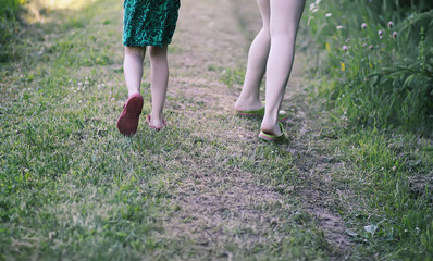 A child's legs running on summer grass.