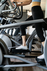 young women working out on stepper at gym