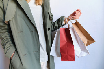 Happy woman holding in hand shopping package. Paper bag. Sale in store. Beautiful young girl in fashion shop. Customer buy present. Black friday sale. Holiday special offer, discount. Female in market