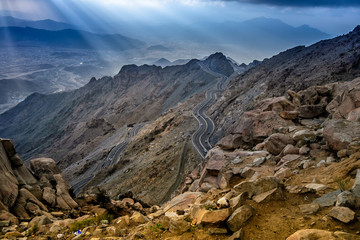 Long exposure of car light trails on a foggy mountain road at Al Huda, Saudi Arabia