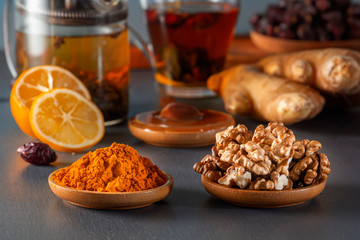 Ginger, walnut, turmeric, honey, lemon, dried rose hips and medicinal herbal tea - a means to increase immunity from the virus. Close-up