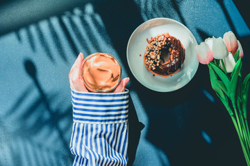 flat lay favorite and trend of summer drink from dalgona or frothy coffee with beauty hand on classic blue and shadow of palm tree background