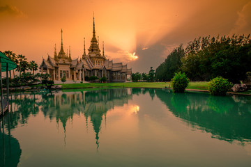Fototapeta premium Wallpaper Wat Lan Boon Mahawihan Somdet Phra Buddhacharn(Wat Non Kum)is the beauty of the church that reflects the surface of the water, popular tourists come to make merit and take a public photo