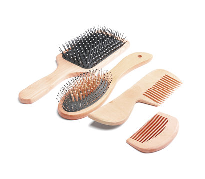Hair brushes and combs on white background