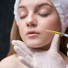 Young pretty woman studio portrait. Cosmetology biorevitalization concept. Esthetic woman injection...