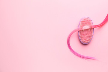 Hair brush and strand on color background